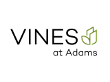 Vibrant 'Vines at Adams' logo featuring modern typography and a subtle leaf design.