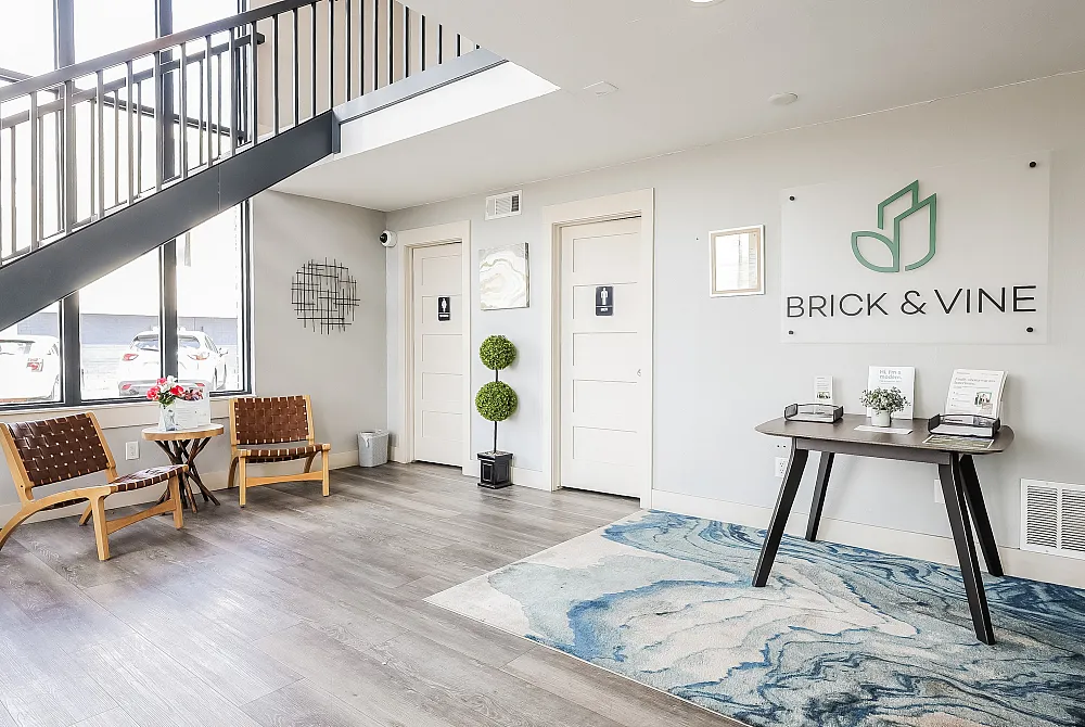 Modern lobby with sleek design featuring large windows, stylish seating, and elegant decor at Brick & Vine.
