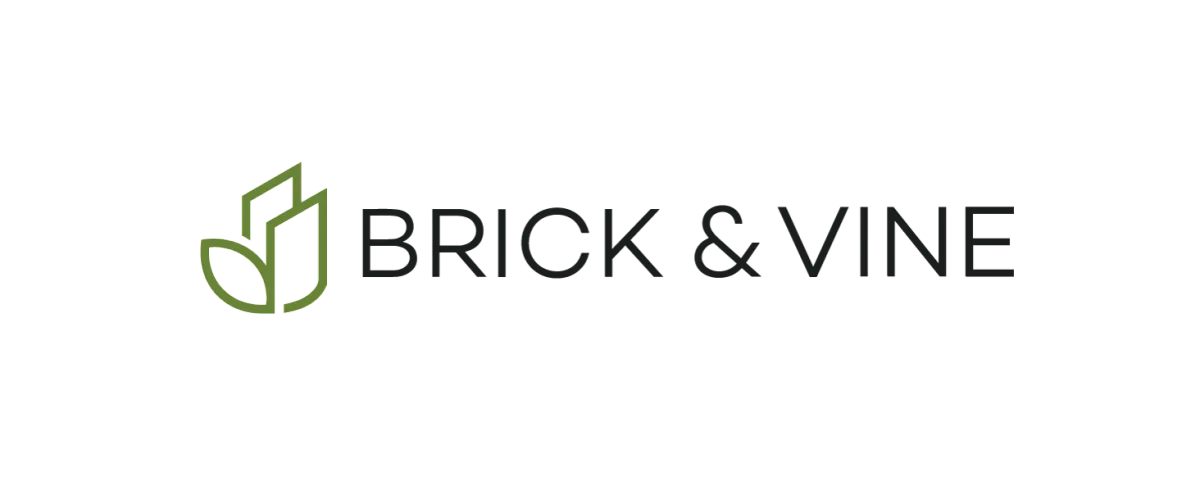Brick & Vine logo with a sleek, modern design featuring a green leaf intertwined with building outlines.