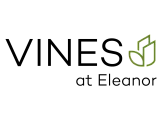 Logo for Vines at Eleanor featuring modern typography with a green leaf design.