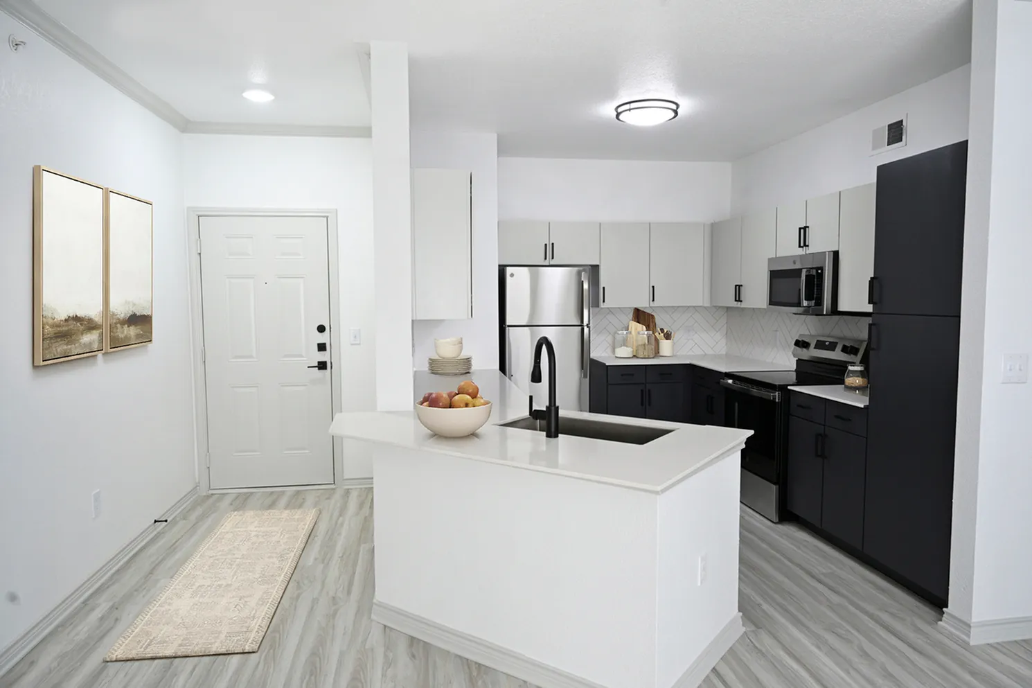 Modern kitchen with sleek countertops, stainless steel appliances, and contemporary cabinetry, creating an inviting and stylish space.