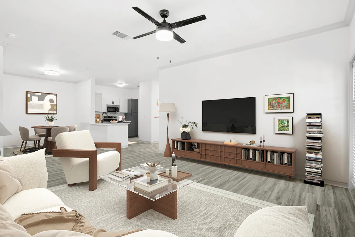 Modern open-concept living room with elegant decor, cozy seating area, and sleek kitchen in the background, perfect for comfort and style.