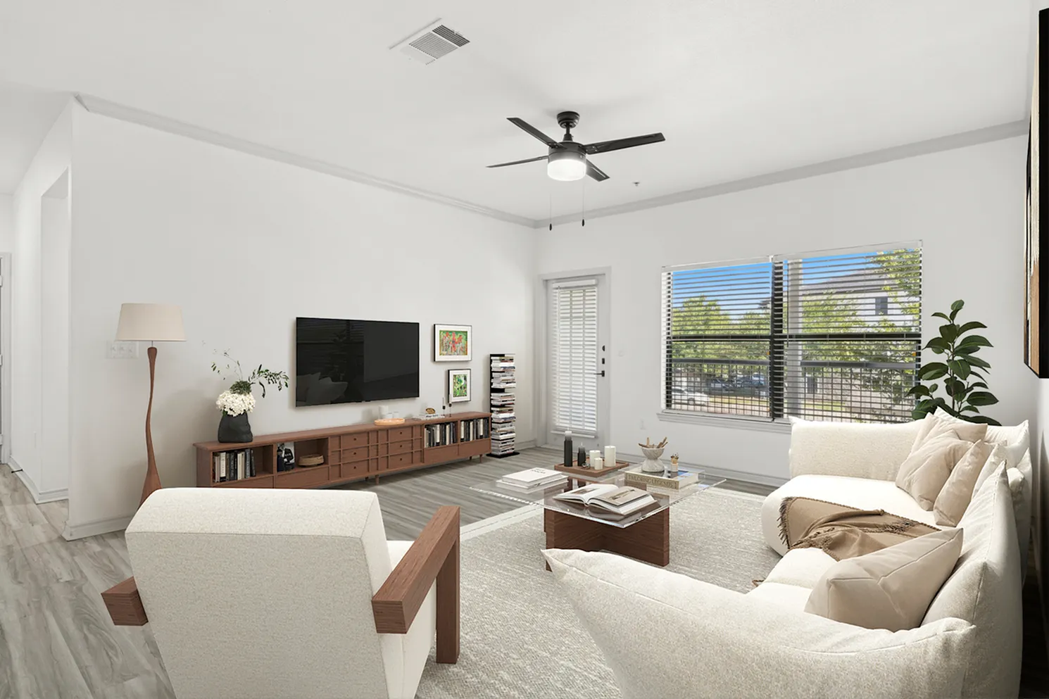 Modern living room with elegant decor, featuring cozy white sofas, a sleek entertainment center, large window with blinds offering natural light, and a stylish ceiling fan.