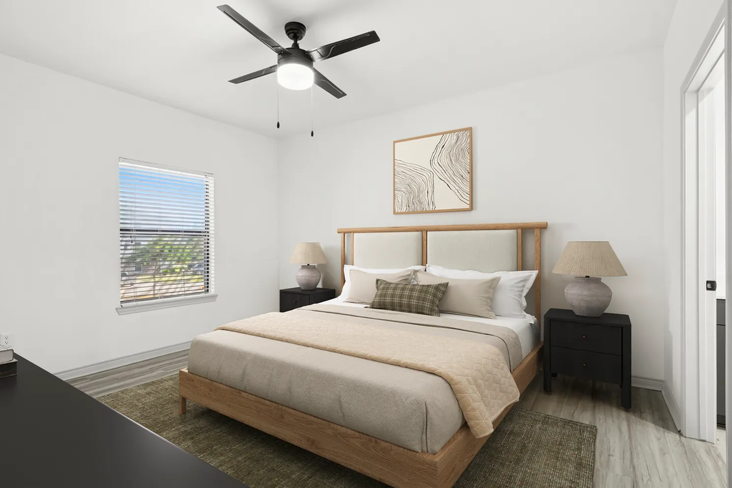 Bright and cozy bedroom with modern ceiling fan, elegant wooden bed, and decorative artwork, creating a serene living space.