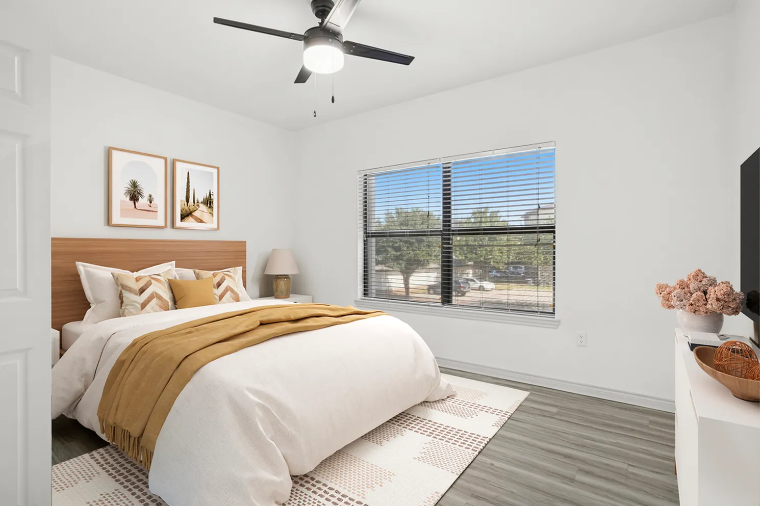 Inviting bedroom with a cozy double bed, elegant decor, and a large window offering natural light and scenic views.
