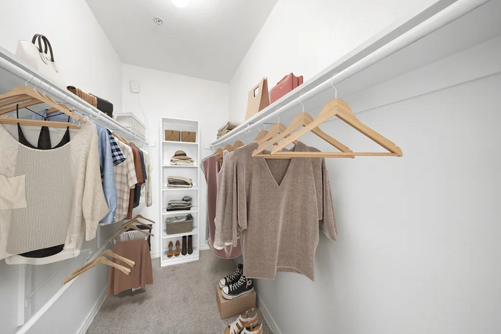 Spacious walk-in closet with ample shelving and hanging space for clothing and accessories.