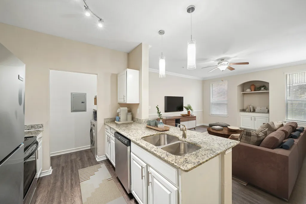 Open concept kitchen with granite counters, pendant lighting, wood floors, stainless appliances