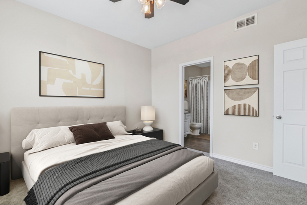 Bedroom wuth plush carpeting, rug, large window, ceiling fan, king size bed with grey and white bedding