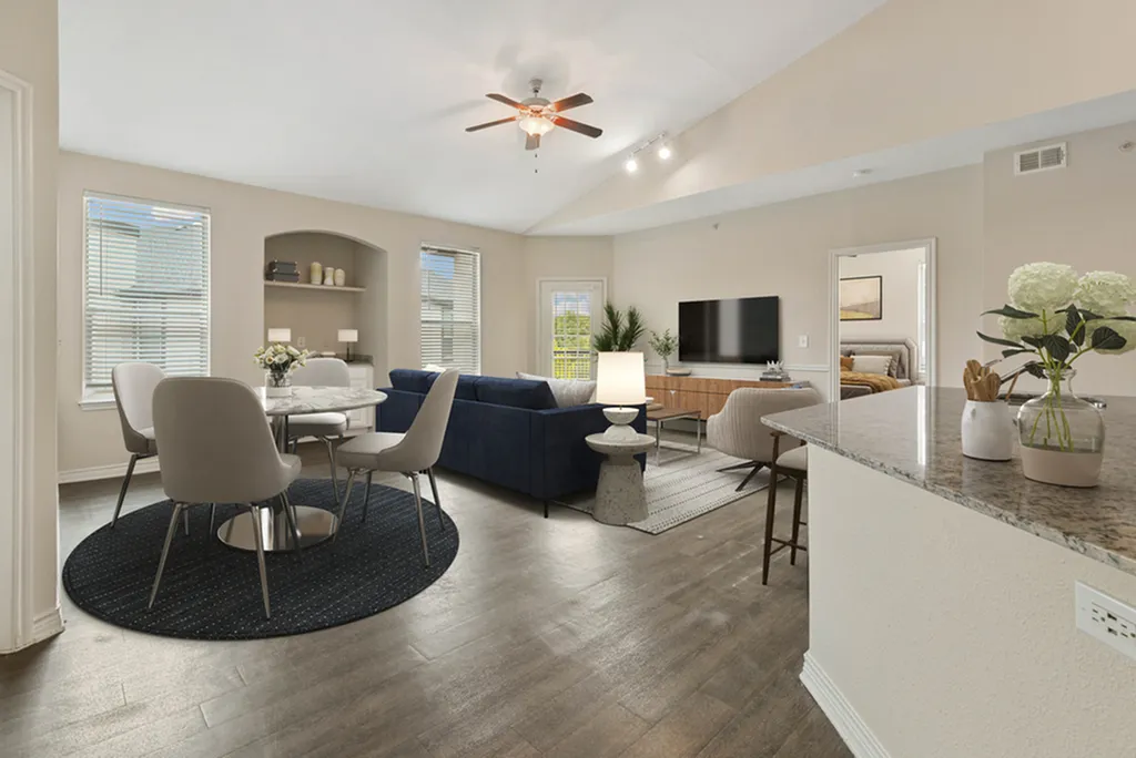 Modern open-concept living and dining area featuring elegant furnishings, chic decor, and large windows for abundant natural light.