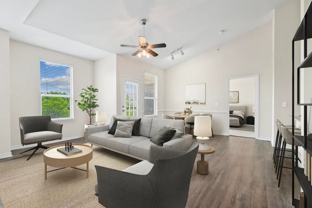 Bright and modern living room featuring comfortable seating, elegant lighting, and abundant natural light with scenic views.
