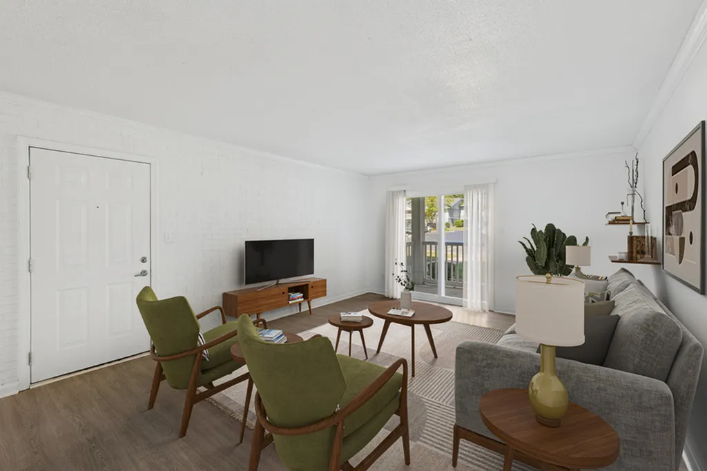Bright and inviting living room with modern decor, featuring a comfortable gray sofa, stylish green chairs, and natural light streaming through large windows.