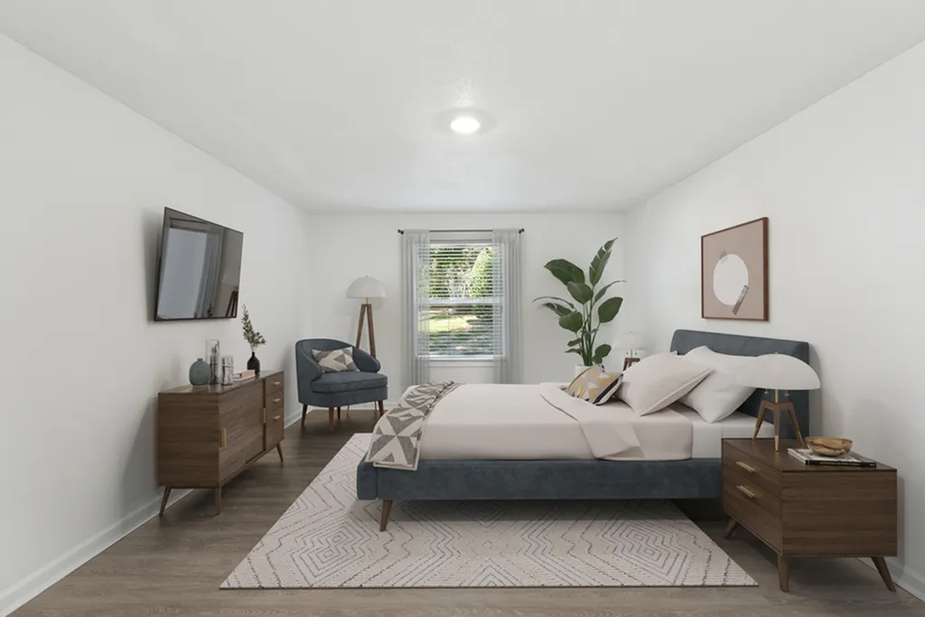 Elegant bedroom with stylish decor, featuring a cozy bed, modern furnishings, and ample natural light from large window.