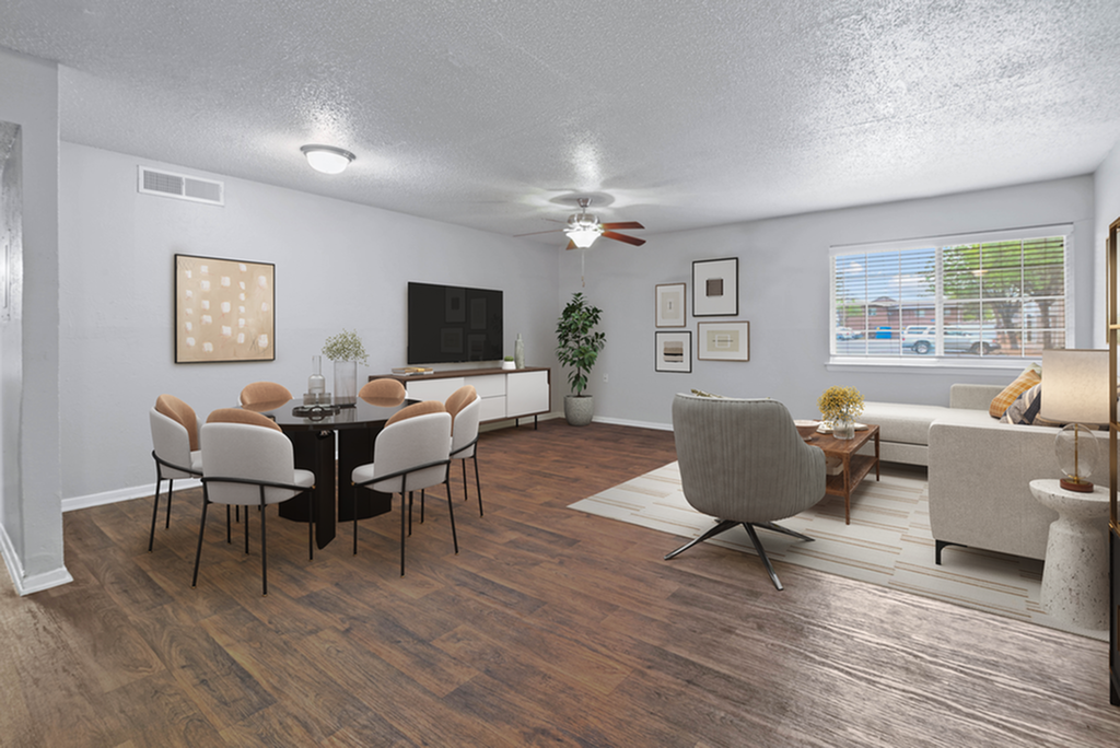 Contemporary open living room and dining area with stylish furnishings and wooden flooring.