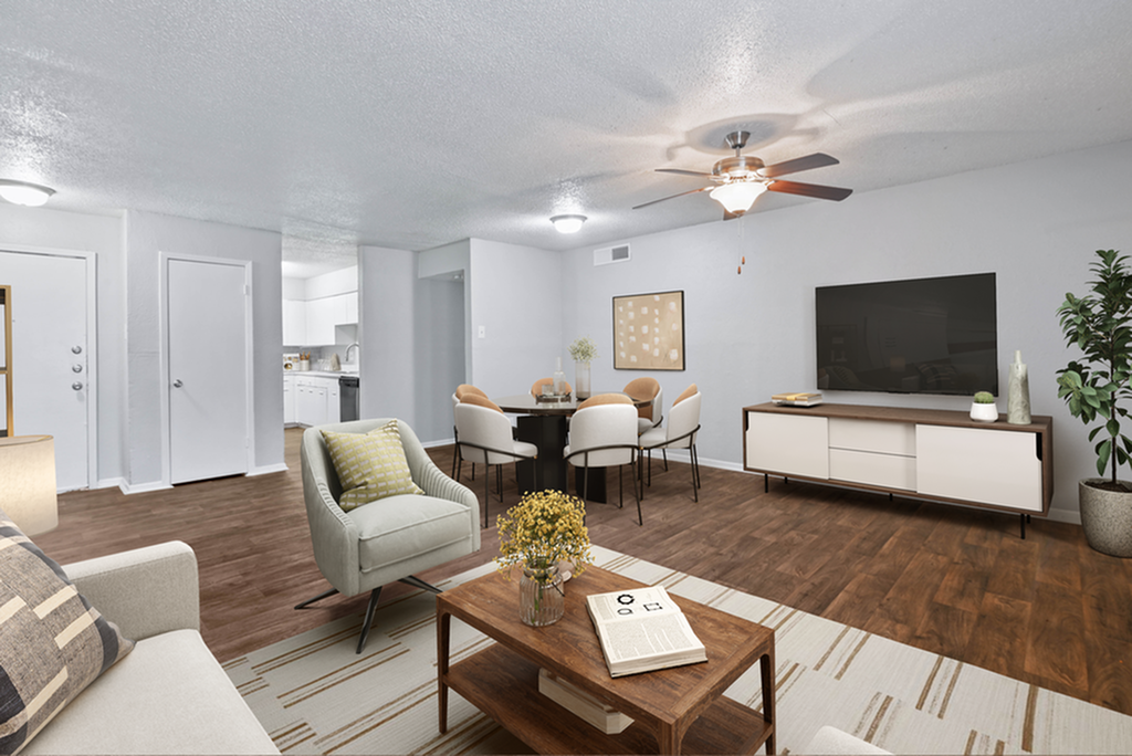 Elegant living room with chic furniture, wooden flooring, a ceiling fan, and adjacent dining area.