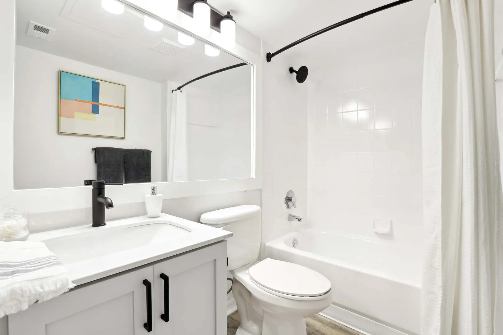 Chic and modern bathroom featuring elegant fixtures, a large mirror, and minimalistic d&eacute;cor.