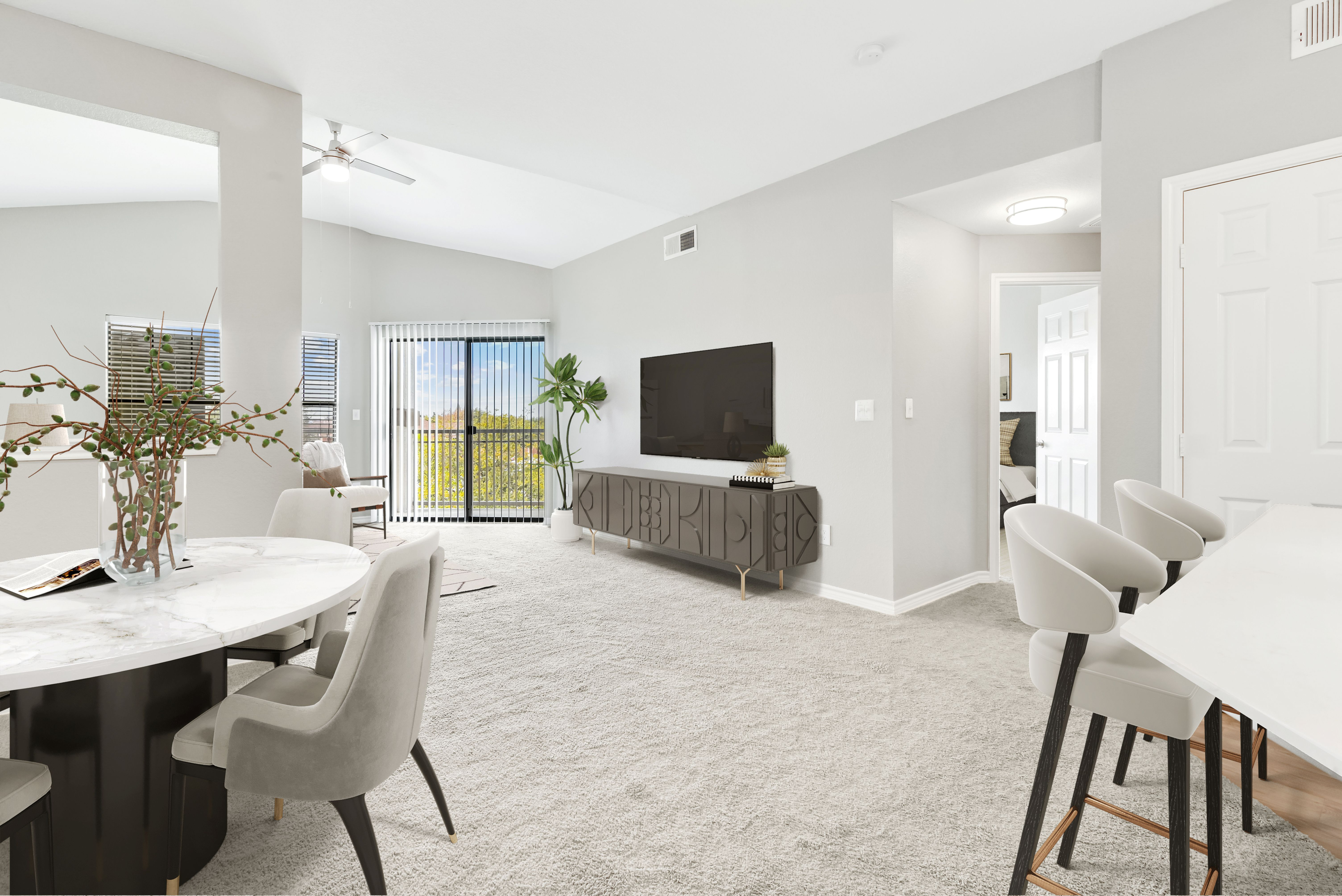 Bright and airy living room with modern decor, open space design, and large windows offering a scenic view.