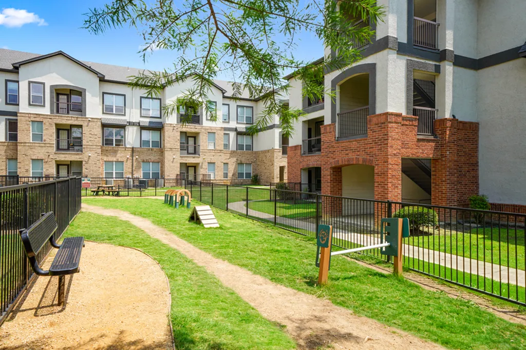 Charming apartment community with fenced-in off leash dog park, outdoor seating, and playful pet agility course, offering modern living in a vibrant community.