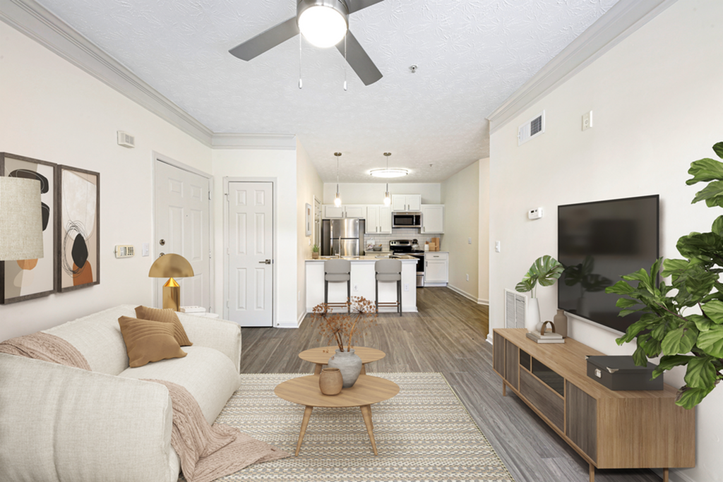 Inviting modern apartment living room with elegant decor, stylish furniture, and open view of a sleek kitchen.