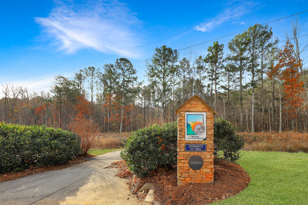Inviting entrance to the Silver Comet Trail surrounded by lush greenery and vibrant woodland scenery.