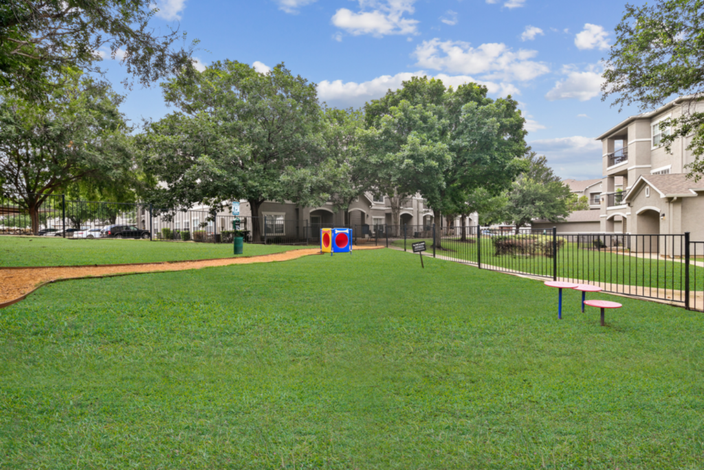 Charming apartment community featuring a lush green dog park, perfect for outdoor enjoyment and relaxation.