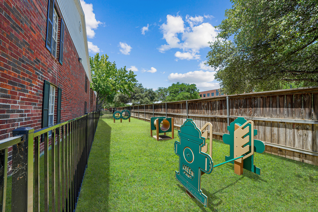 Charming enclosed dog park featuring an agility course, perfect for leisure and enjoyment.