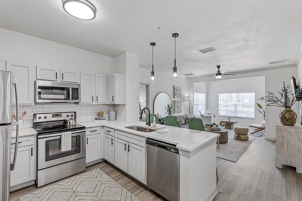 Modern open-plan apartment showcasing a sleek kitchen, stylish living area, and abundant natural light.
