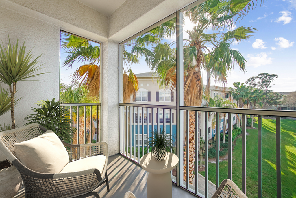 Charming balcony with cozy seating and lush palm views, perfect for relaxation and enjoying the scenic surroundings.