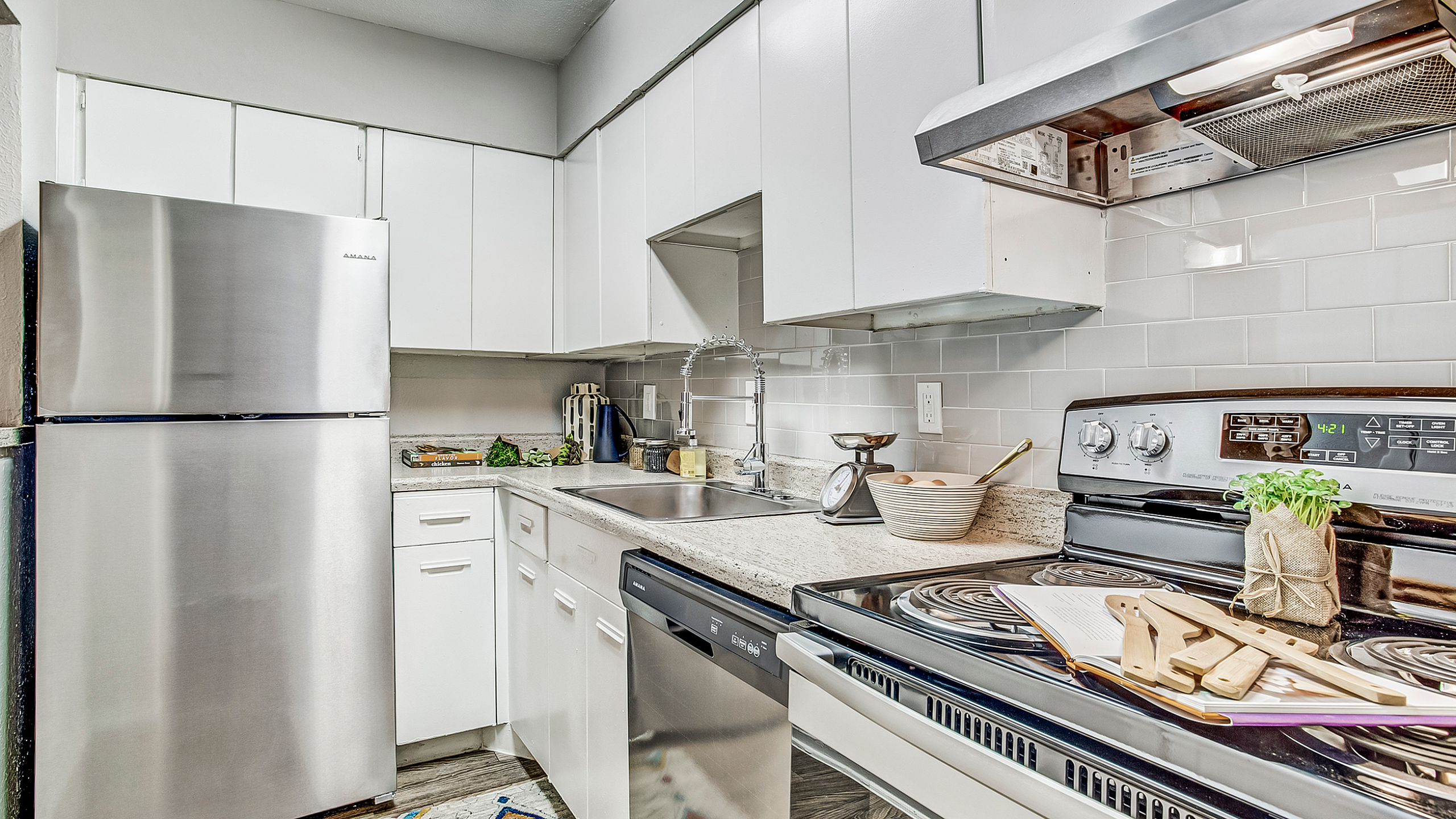 Kitchen with Vinyl floors, stainless-steel appliances, white quartz countertop,