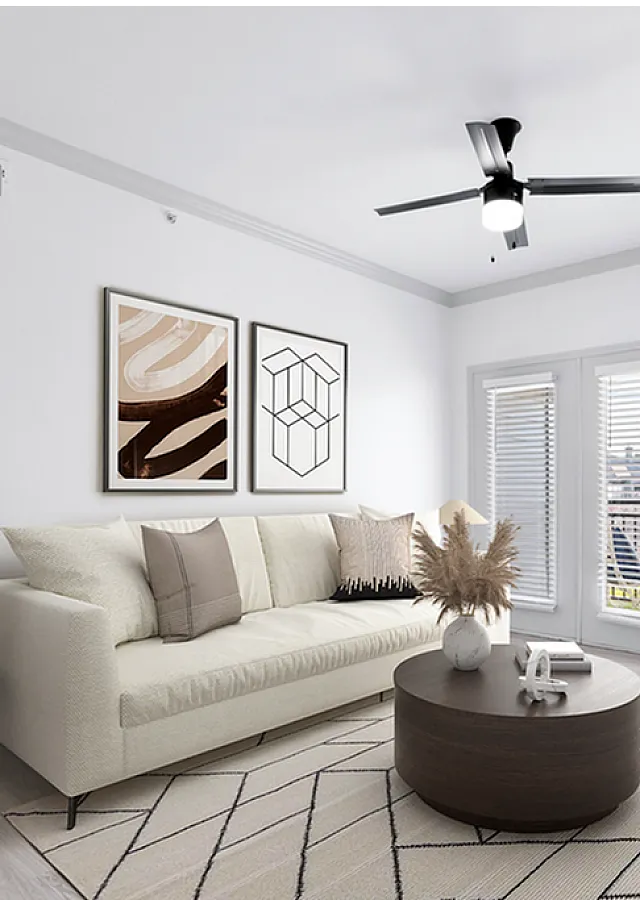 Bright and modern living room featuring a cozy sofa, chic artwork, and elegant decor, with sunlight streaming through large French doors.