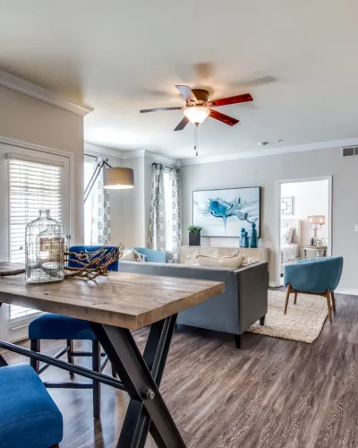 Inviting living space with modern decor, featuring a cozy seating area, stylish dining table, and elegant artwork under soft natural light.