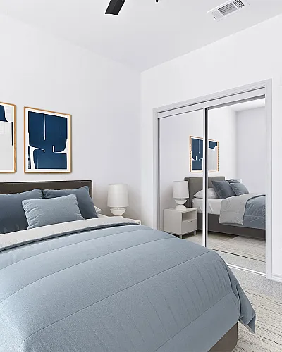 Bright and modern bedroom with stylish blue accents, plush bed, mirrored closet, and elegant wall art.
