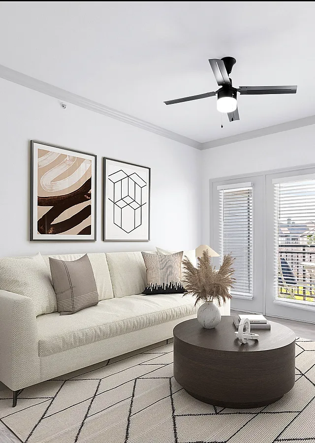 Bright and modern living room with elegant decor, featuring a cozy sofa, stylish coffee table, and wall art. Natural light pours through large windows, highlighting the chic design.