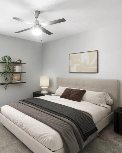 Cozy contemporary bedroom with a modern upholstered bed, neutral bedding, and soft gray walls. The room features a ceiling fan, stylish bedside lighting, minimalist wall art, floating shelves with d&eacute;cor accents, and plush carpeting f