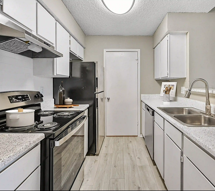 Modern kitchen with sleek countertops, contemporary appliances, and abundant cabinetry for a stylish culinary experience.