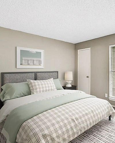 Bright and cozy bedroom featuring a stylish bed, modern lamps, and ample natural light through large windows and glass door.