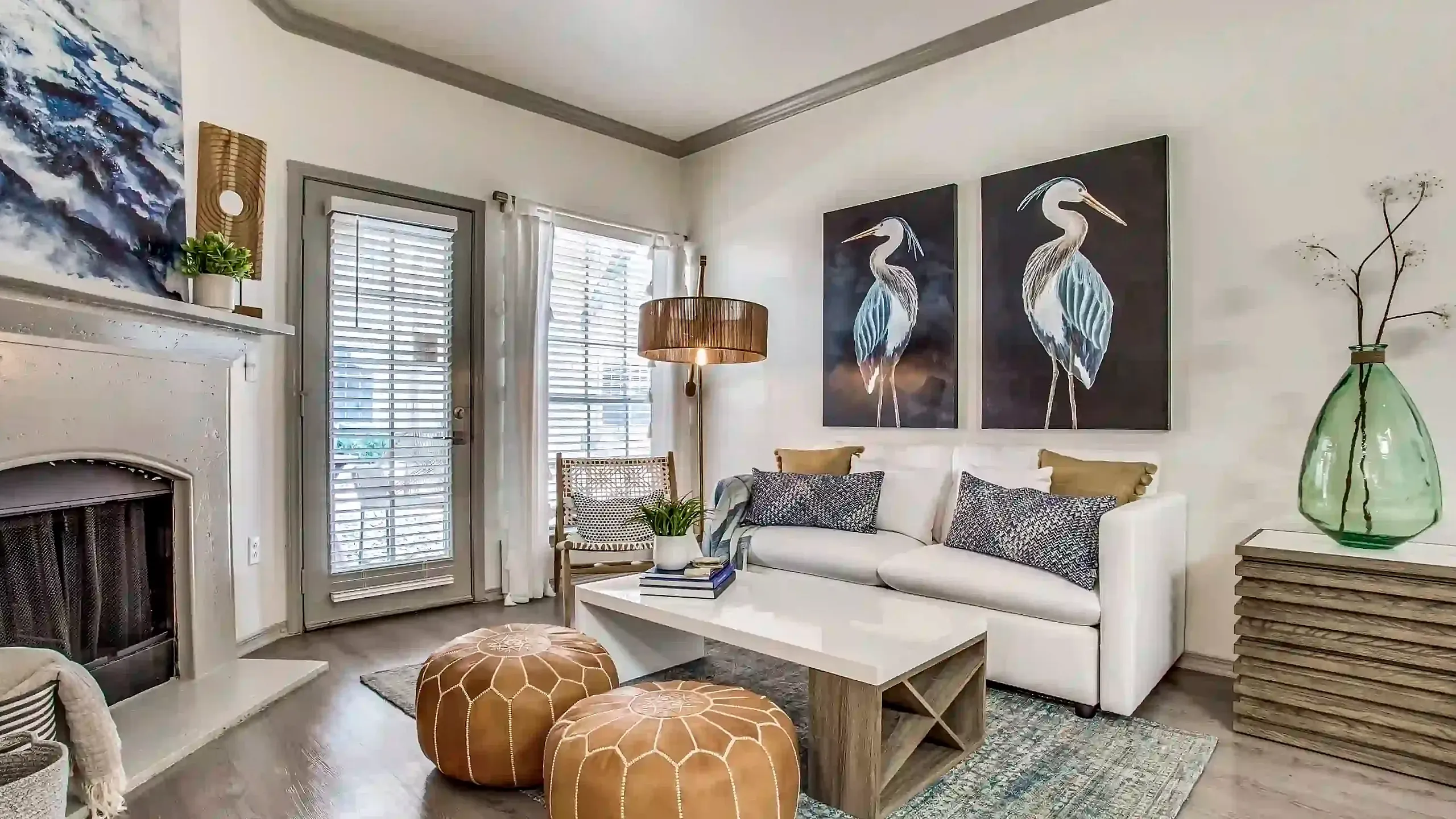 Charming living room with elegant fireplace, cozy white sofa, stylish decor, and large artworks creating a cozy and inviting atmosphere.