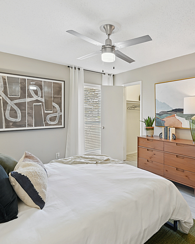 Inviting bedroom featuring modern decor, sleek furniture, and natural light creating a tranquil ambiance.