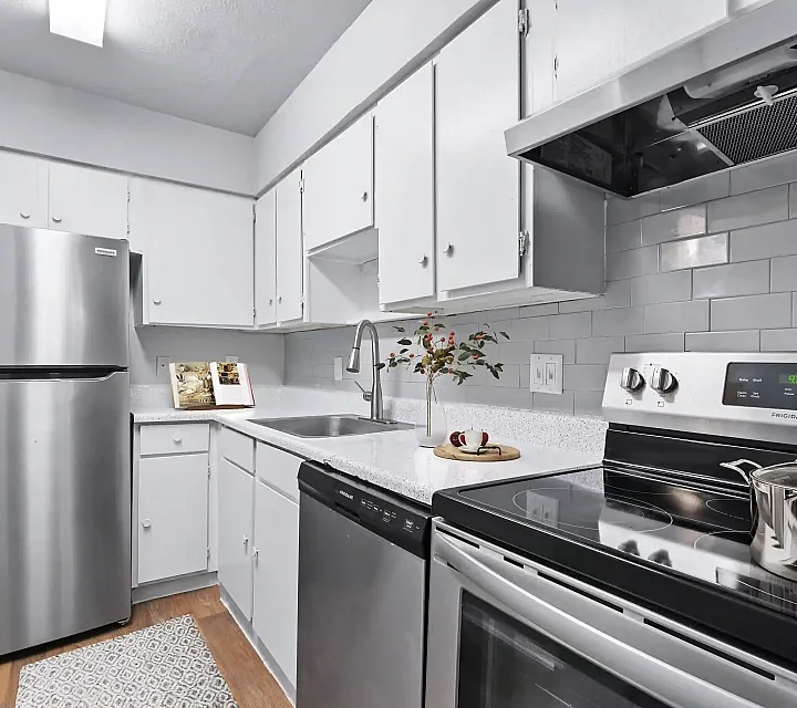 Kitchen with Vinyl floors, stainless-steel appliances, white quartz countertop,