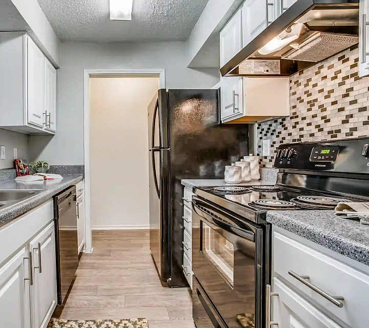 Chic modern kitchen with sleek countertops, stainless steel appliances, and stylish backsplash for a contemporary look.