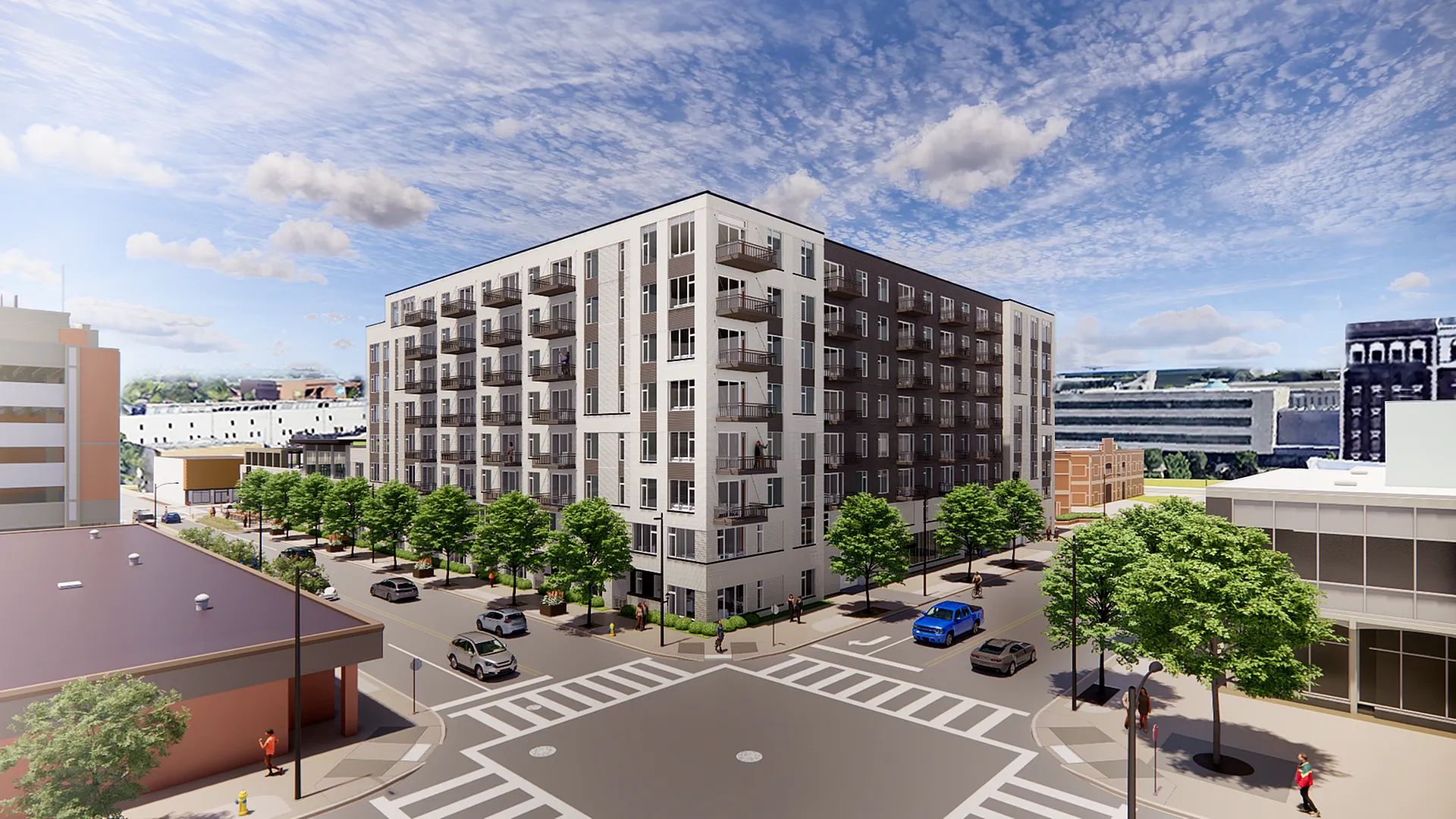 Modern apartment complex with spacious balconies nestled in a vibrant urban setting, featuring lush green trees along a bustling street corner.