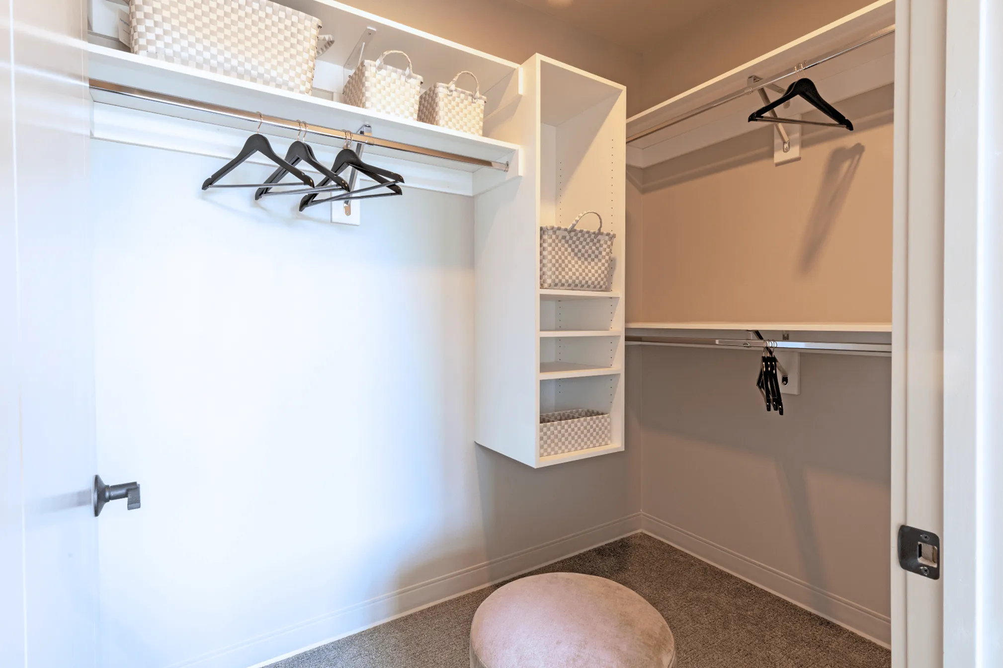 Spacious and organized walk-in closet with modern shelving, elegant hangers, and stylish storage baskets.