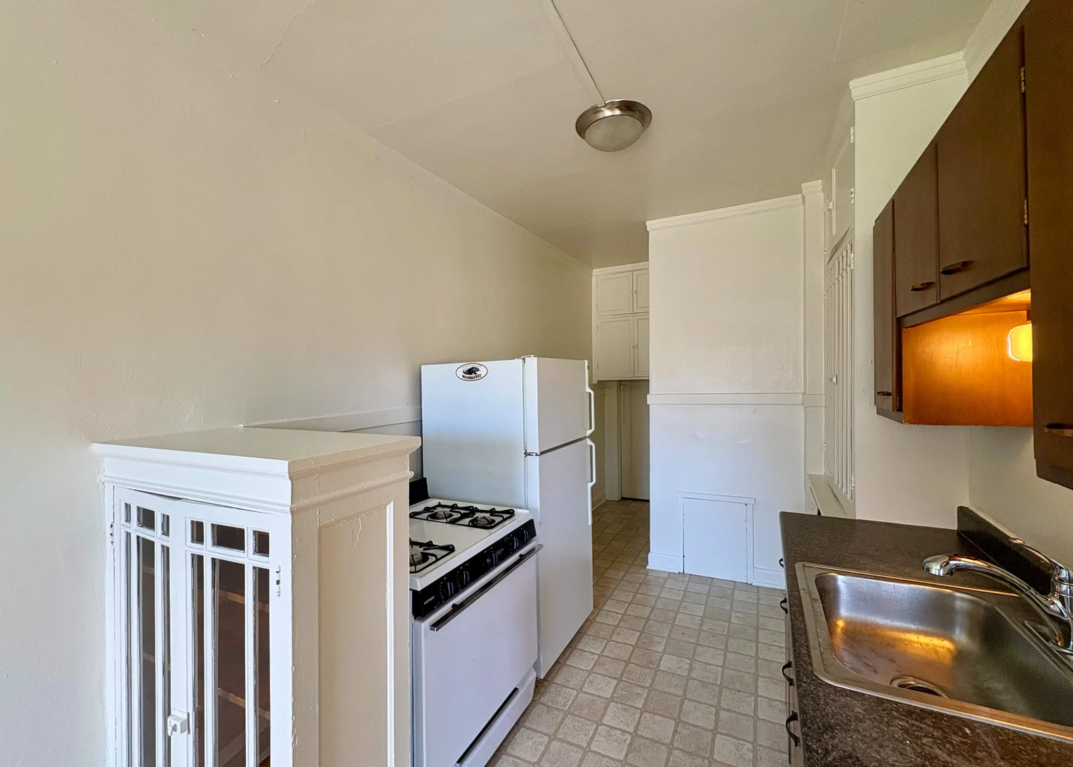 Charming kitchen with a vintage vibe, featuring modern appliances and ambient lighting, ideal for cozy home cooking.