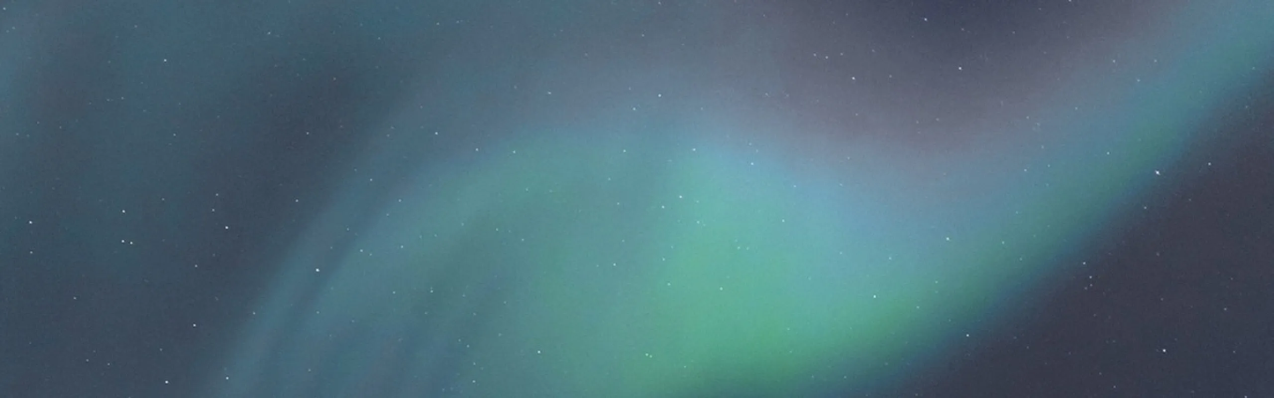 Mesmerizing night sky with vibrant green and blue aurora borealis dancing amidst sparkling stars.