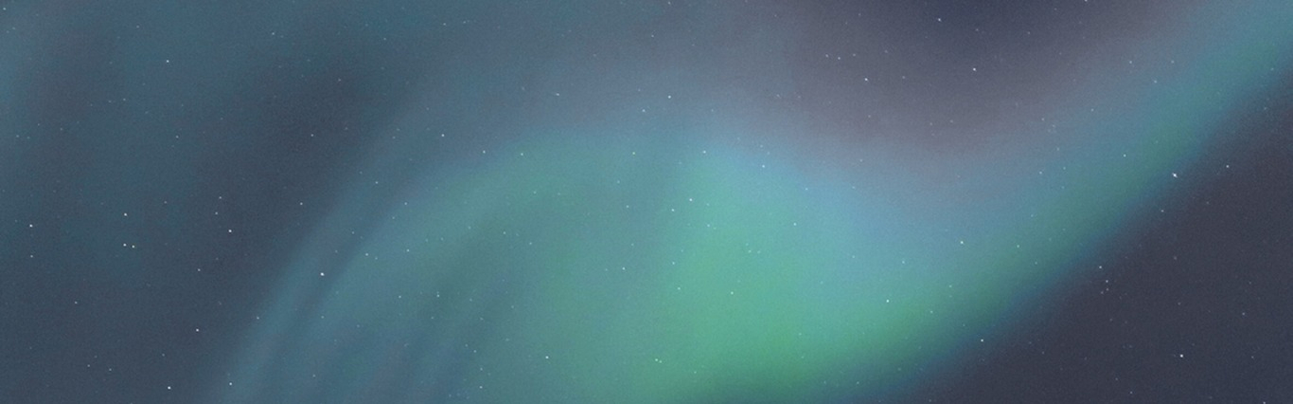Captivating view of the vibrant Northern Lights illuminating the night sky with enchanting green and blue hues.