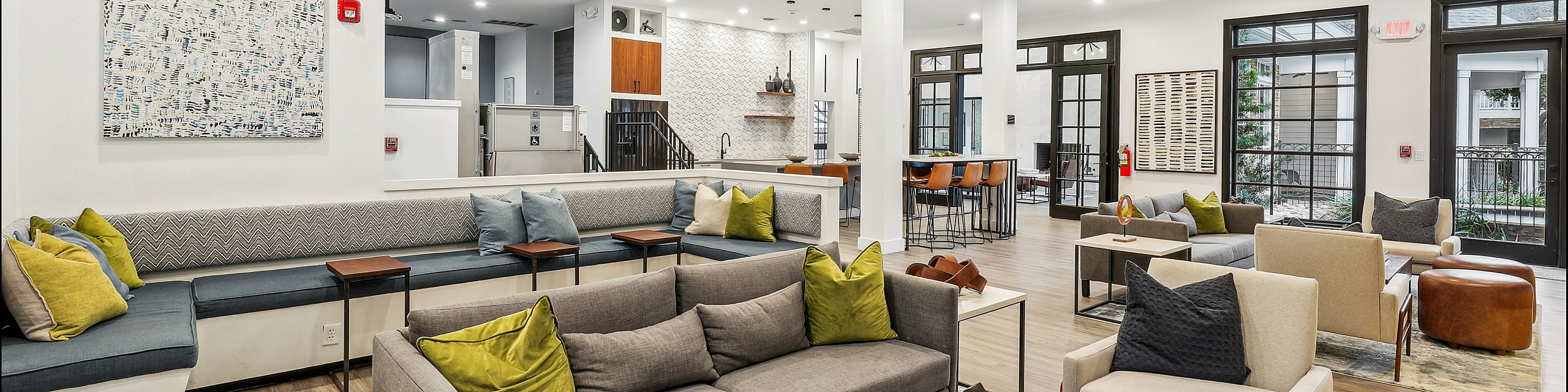 Luxurious lounge area with modern decor, ample seating, and natural lighting, perfect for relaxation and social gatherings.