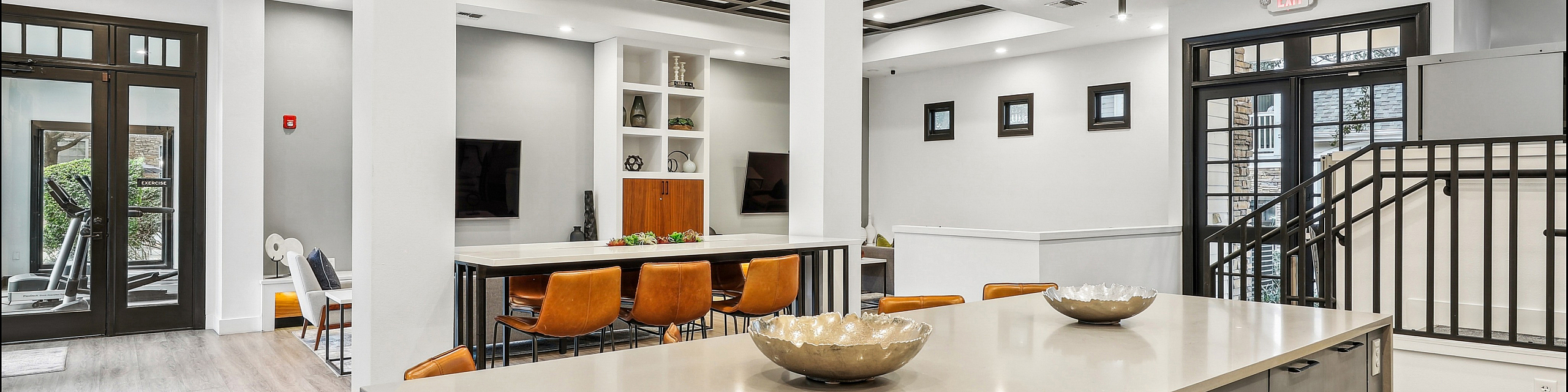 Elegant, contemporary open-concept space featuring a modern kitchen island, sleek dining area with leather chairs, and bright seating lounge, perfect for stylish living.