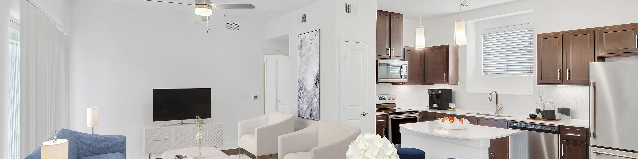Modern open-concept living space with elegant furnishings, a sleek kitchen, and abundant natural light.