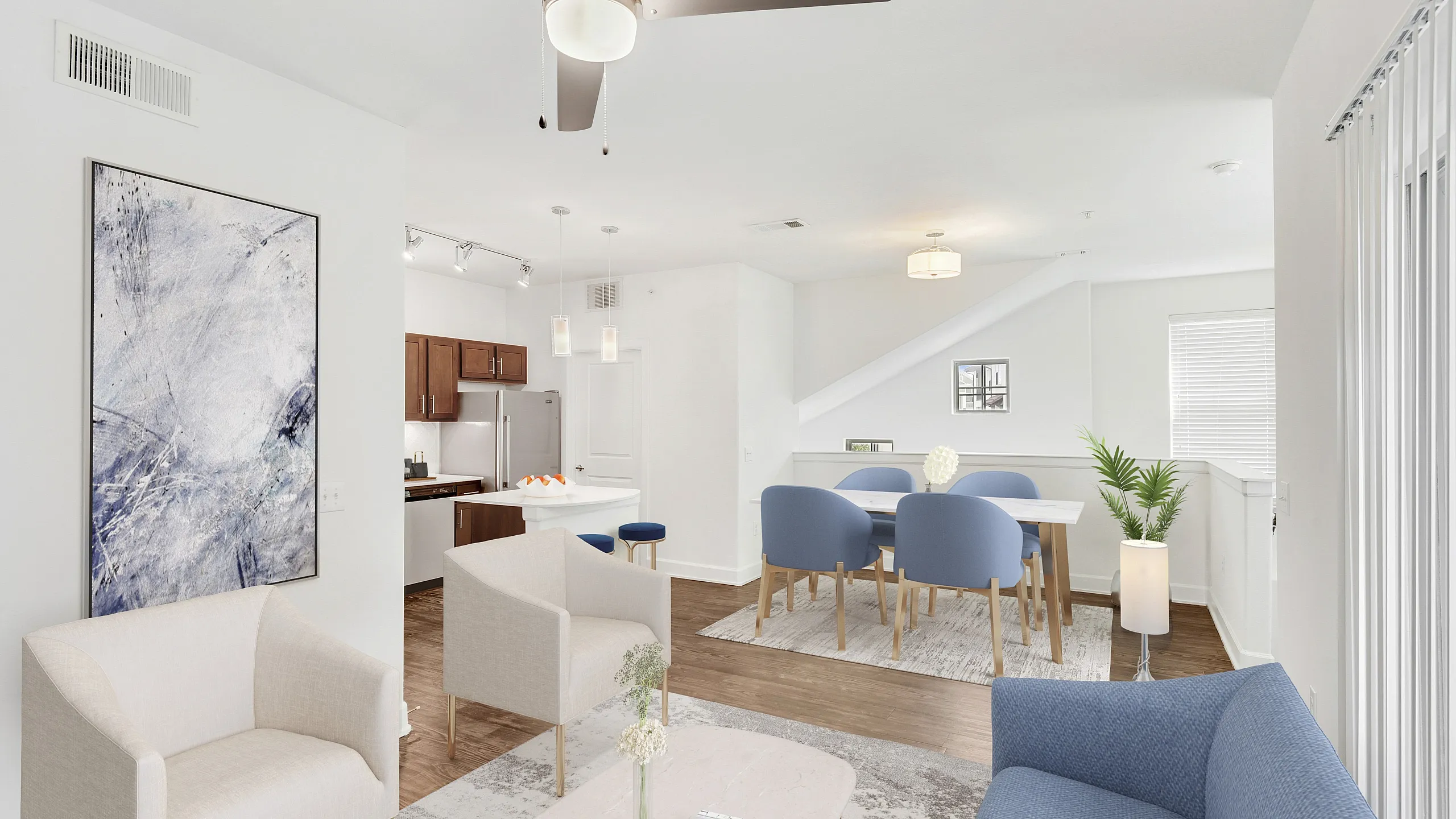 Elegant modern living room with stylish furniture, open-concept dining area, and sleek kitchen design.