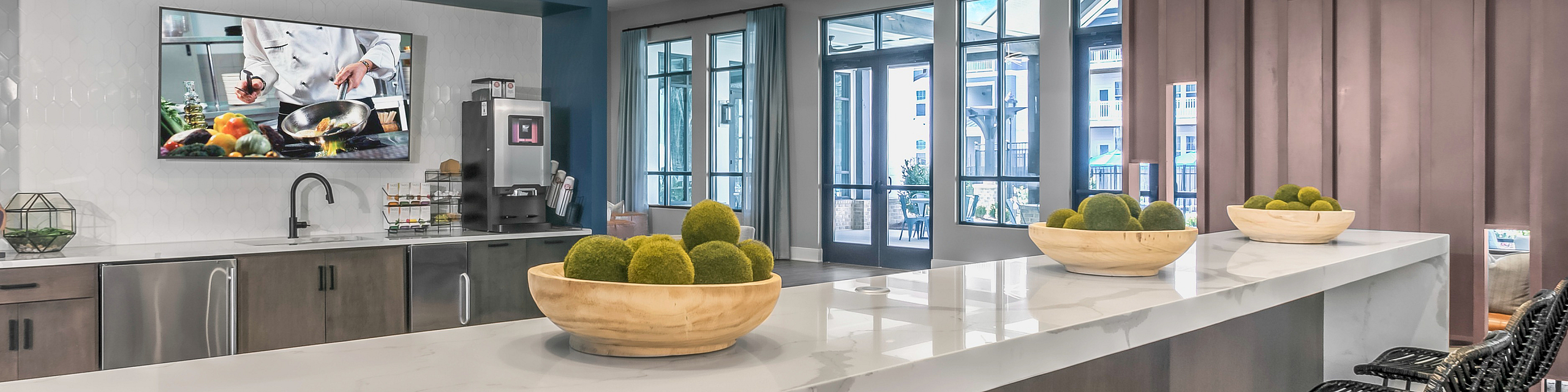 Chic modern kitchen with elegant high ceilings, sleek countertops, pendant lighting, and stylish bar seating.