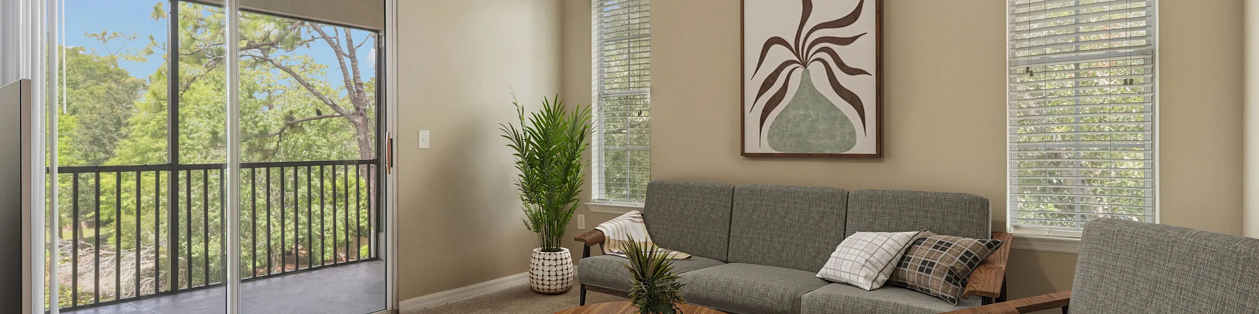 Inviting living room with modern decor, cozy seating, and a serene view through large sliding doors, complemented by lush greenery outside.